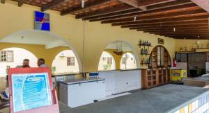 a restaurant with arches and a counter in a room at Quarto139 Portobello Park in Porto Seguro