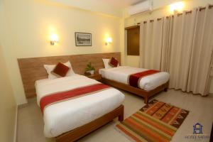 Uma cama ou camas num quarto em Hotel Sadan