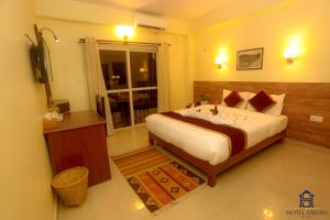 Uma cama ou camas num quarto em Hotel Sadan
