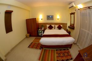 Uma cama ou camas num quarto em Hotel Sadan