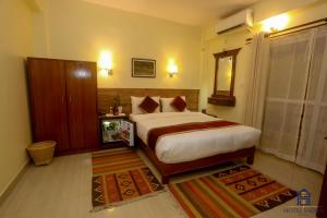 Uma cama ou camas num quarto em Hotel Sadan