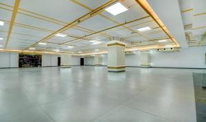 a large hall with a large white floor and ceilings at Treebo Trend Siesta Muralinagar in Visakhapatnam