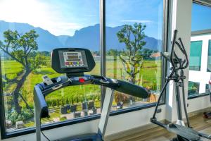 a gym with a treadmill in front of a window at TEVA Valley Resort in Chiang Rai