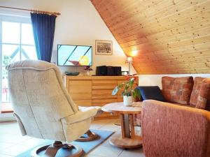 a living room with a couch and a table at Ferienhaus Weinhardt - Whg 2 in Zingst