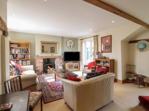a living room with a couch and a fireplace at The Old Custom House in Halesworth
