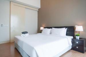 a bedroom with a large white bed and a large window at Platinum Suites at Swiss Garden in Kuala Lumpur