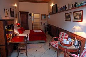 a bedroom with a bed and a table and chairs at Les Chambres de Mathilde in Angers