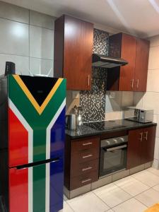 a kitchen with a colorful refrigerator in a kitchen at Rhino House with 3 bedrooms next to Pilanesberg and Sun City in Mogwase