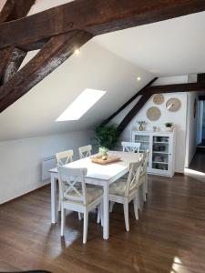 a white dining room with a white table and chairs at La Cantina in Charleville-Mézières +16 photos