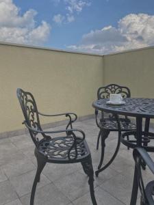 a table and chairs with a coffee cup on a patio at Prestige Apartments Kalnyshevskogo in Dnipro