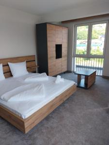 a bedroom with a large bed and a table at Motel Bajra in Travnik
