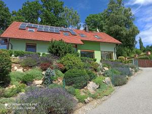 a house with solar panels on the roof at Apartmá Na Lipně in Horní Planá