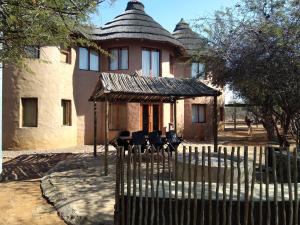 a house with a fence in front of it at KweKwe Private Game Lodge in Marble Hall