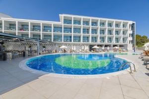 a swimming pool in front of a hotel at River Rock Hotel in Ayia Napa