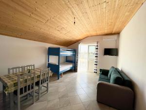 a living room with a couch and a table at Doçi Seven Hotel in Velipojë