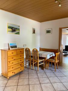 a dining room with a table with a laptop on it at Gödelsteinhof in Contwig