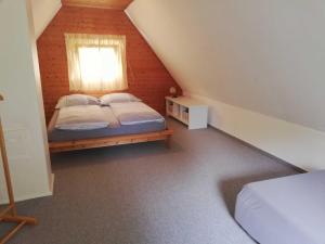 a attic bedroom with a bed and a window at Ferienhaus ruhige Lage _ strandnah in Ueckeritz