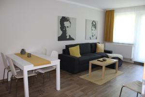 a living room with a couch and a table at Gästewohnung in Niesky in Niesky