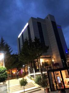 a tall building with lights on it at night at Resort Zerja and Spa in Peshkopi