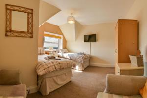 a bedroom with two beds and a living room at The Whitby Prospect in Whitby