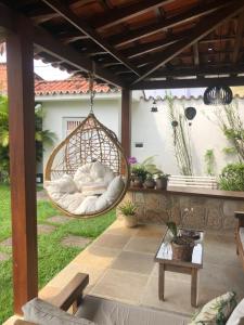 a hanging hammock on the patio of a house at Pousada Romã in Paraty