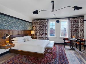 a bedroom with a large bed and a large window at Hotel Revival Baltimore, part of JdV by Hyatt in Baltimore