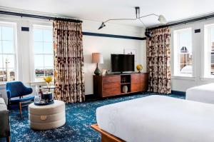 a bedroom with a large bed and a television at Hotel Revival Baltimore, part of JdV by Hyatt in Baltimore