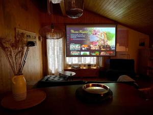 a living room with a tv and a table at Highest terrace Verbier center. Top comfort & view in Verbier