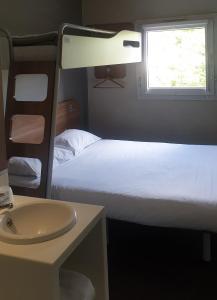 a bedroom with two bunk beds and a sink at SUN1 BENONI in Benoni
