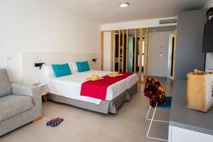 a bedroom with a large bed and a couch at Hotel Taimar in Costa Calma