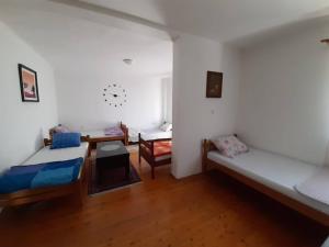 a room with two beds and a table in it at Hostel Raft Neretva in Konjic