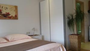 a bedroom with a bed and a potted plant at Apartments Jani in Hvar