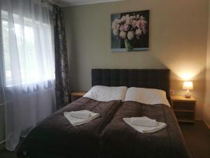 Cama o camas de una habitación en Svečių namai Banga