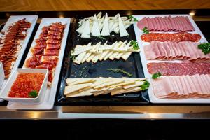 a buffet of different types of meats and cheese at Hotel Taimar in Costa Calma