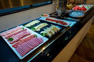 a buffet line with different types of meats and appetizers at Hotel Taimar in Costa Calma