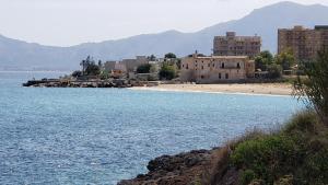 a group of buildings on the shore of a body of water at Duchi in Palermo