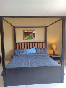 a bedroom with a bed with a blue comforter at Gold Coast Morib Resort in Banting