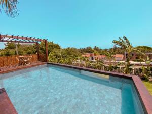 a swimming pool with a table and a patio at UMAMI RESIDENCE in Icaraí
