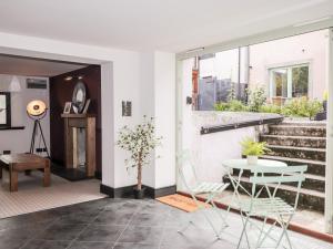 a living room with a table and chairs and stairs at Mary Ann Apartment in Inverness