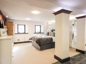 a bedroom with a bed and a white column at Mary Ann Apartment in Inverness