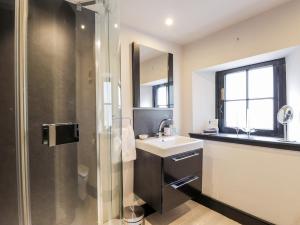 a bathroom with a sink and a shower at Mary Ann Apartment in Inverness +19 photos