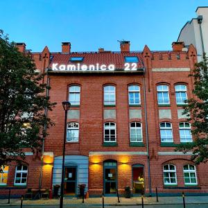a red brick building with a sign on it at Kamienica 22 Old Town in Gdańsk