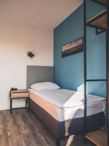 a bedroom with a bed and a bunk bed at Sabotin, Hotel & Restaurant in Nova Gorica