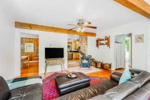 a living room with a couch and a flat screen tv at Country Escape in Clinton