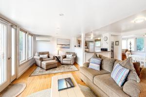 a living room with a couch and a table at Lupine Cottage in Owls Head