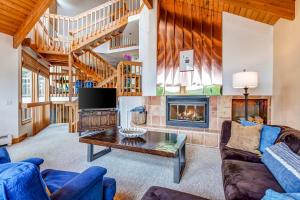 a living room with a couch and a fireplace at Pinnacle Peak in Park City