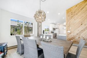 a dining room with a wooden table and chairs at Blue Water in Garden City