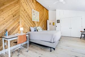 a bedroom with a bed and a desk with a desk at Blue Water in Garden City