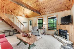a living room with a fireplace and a wooden ceiling at Fresh Ayres Getaway in Banner Elk