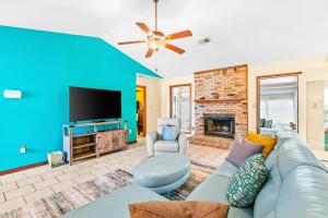 a living room with a couch and a tv at Pleasant Palms in Navarre